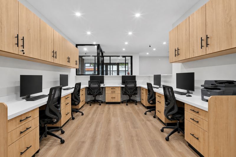 Reception and billing office with six computer workstations and a printer