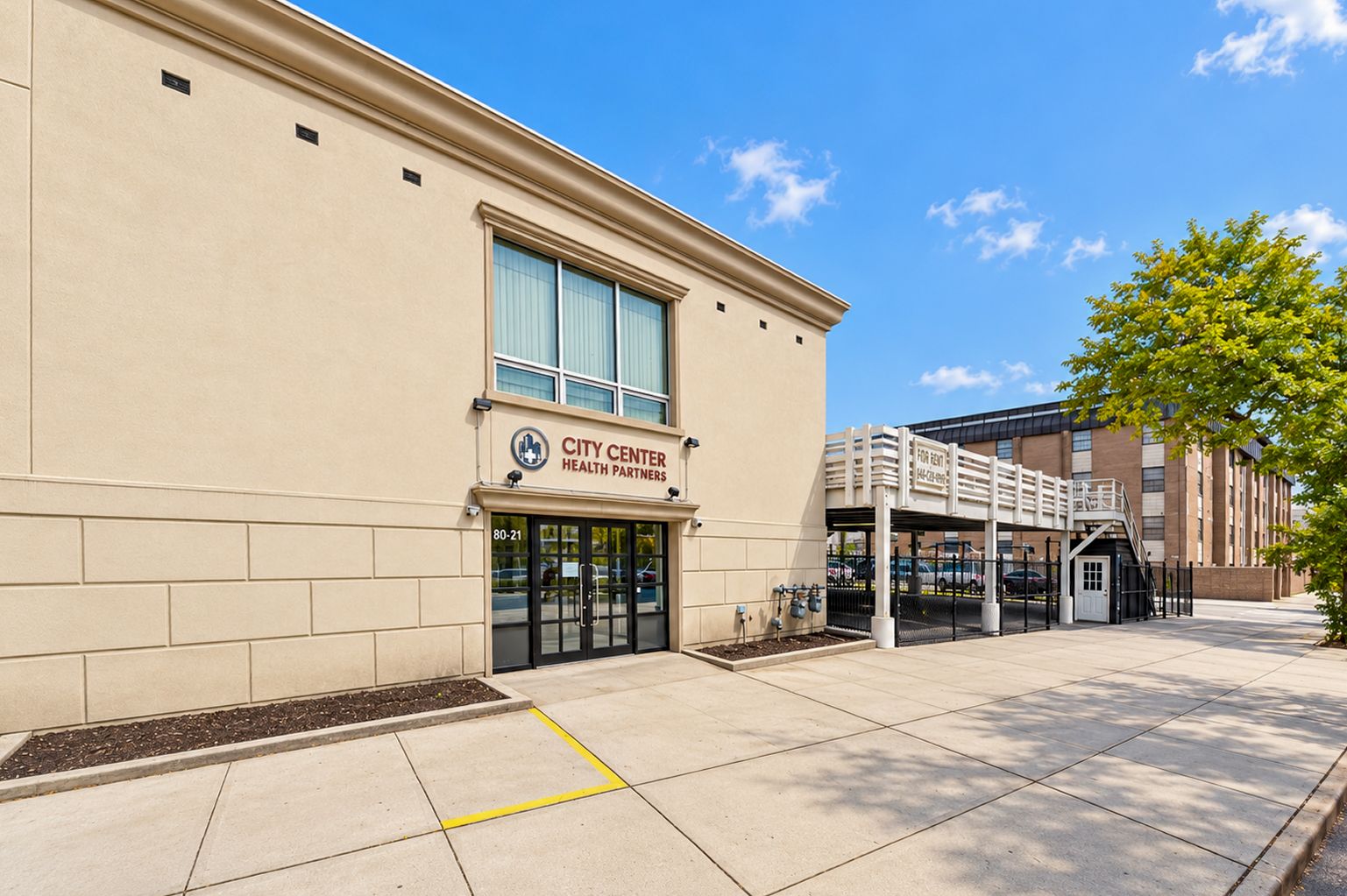 Building entrance at 80-21 164th Street with the City Center Health Partners sign above the doors